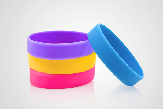 A stack of colored silicone wristbands for children without print